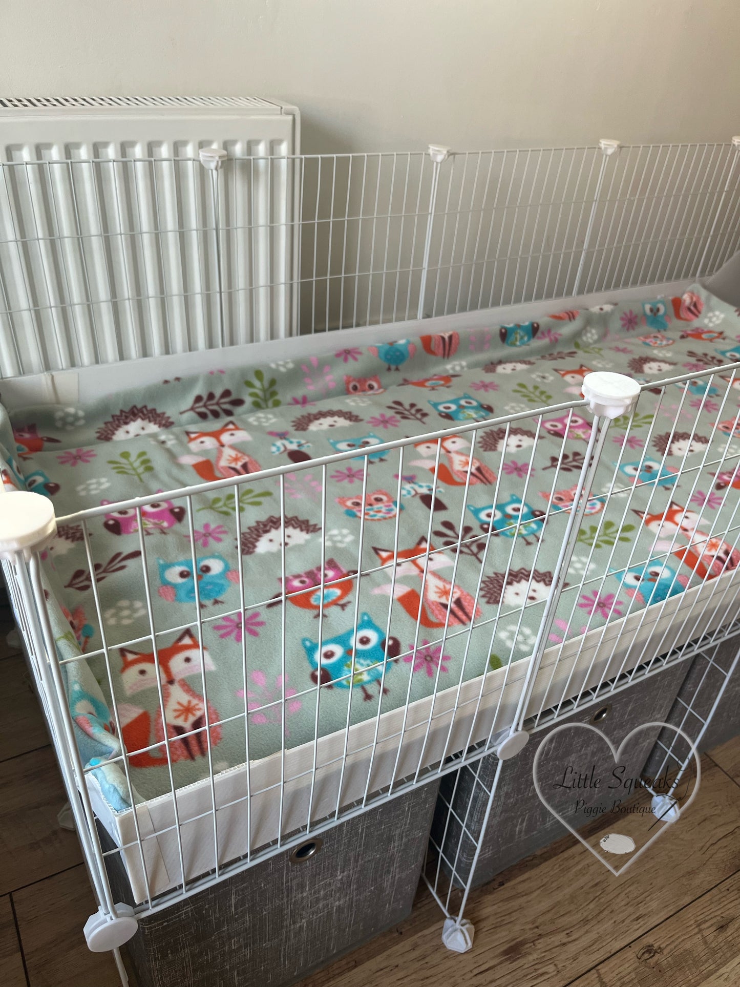 Woodland Friends guinea pig fleece cage liner laid out in a guinea pig cage